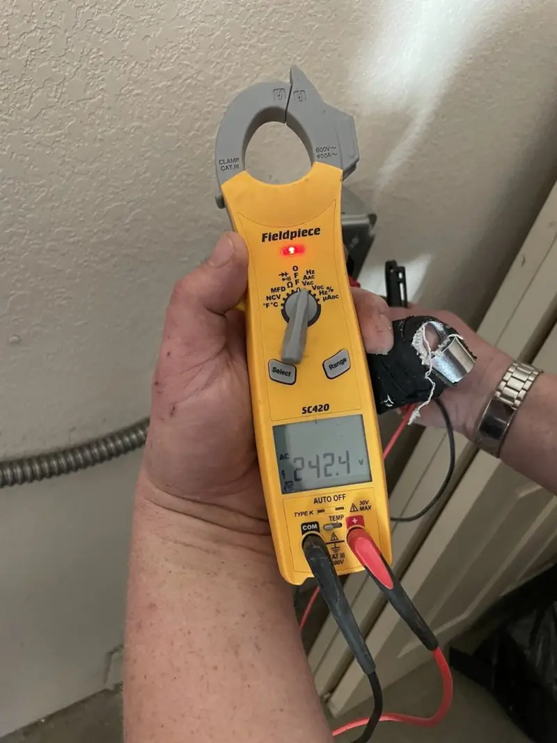 Voltage testing with clamp meter during Outlet Installation in Monee